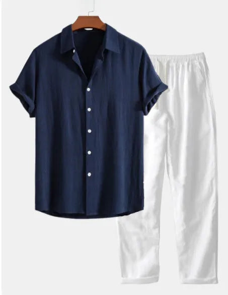 Man wearing a loose navy blue cotton linen short sleeve shirt and shorts beachwear set with glasses, shoes and watch.