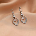 Gold and silver women's drop tassel earrings with zircon detail on a water drop shape.