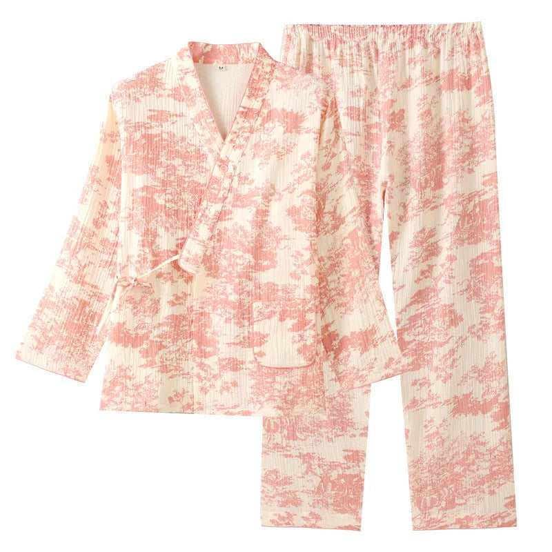 Women's pink pure cotton gauze suit with long sleeves and lace-up trousers on a hanger.