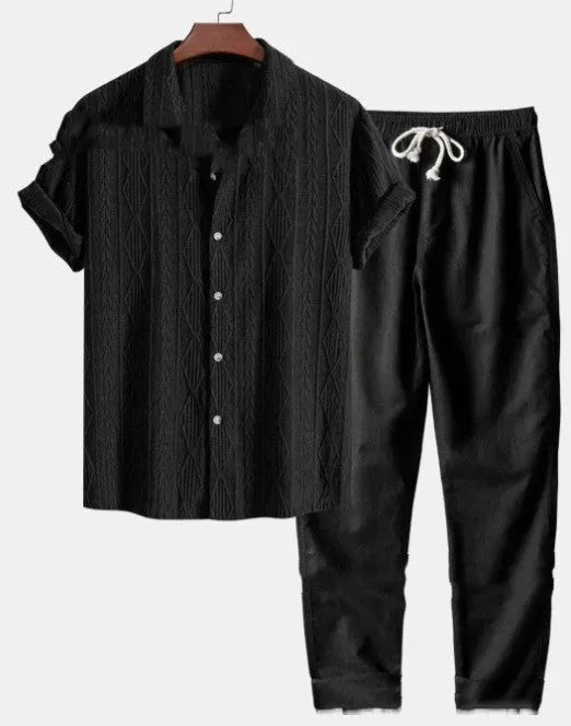 Man wearing a loose-fit short sleeve shirt and trousers from the milk silk polyester summer suit in a neutral colour.