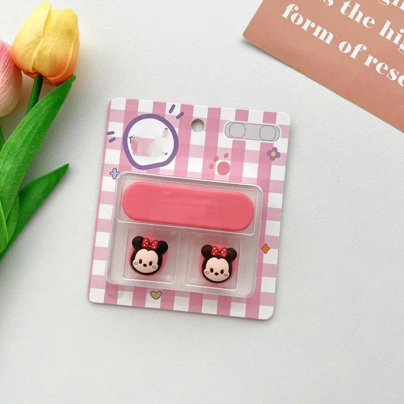 Colourful cartoon character plastic clip holding a magnetic charging cable on a desktop