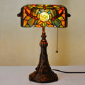 10-inch Tiffany desk lamp with coloured stained glass shade and resin base on a wooden table.