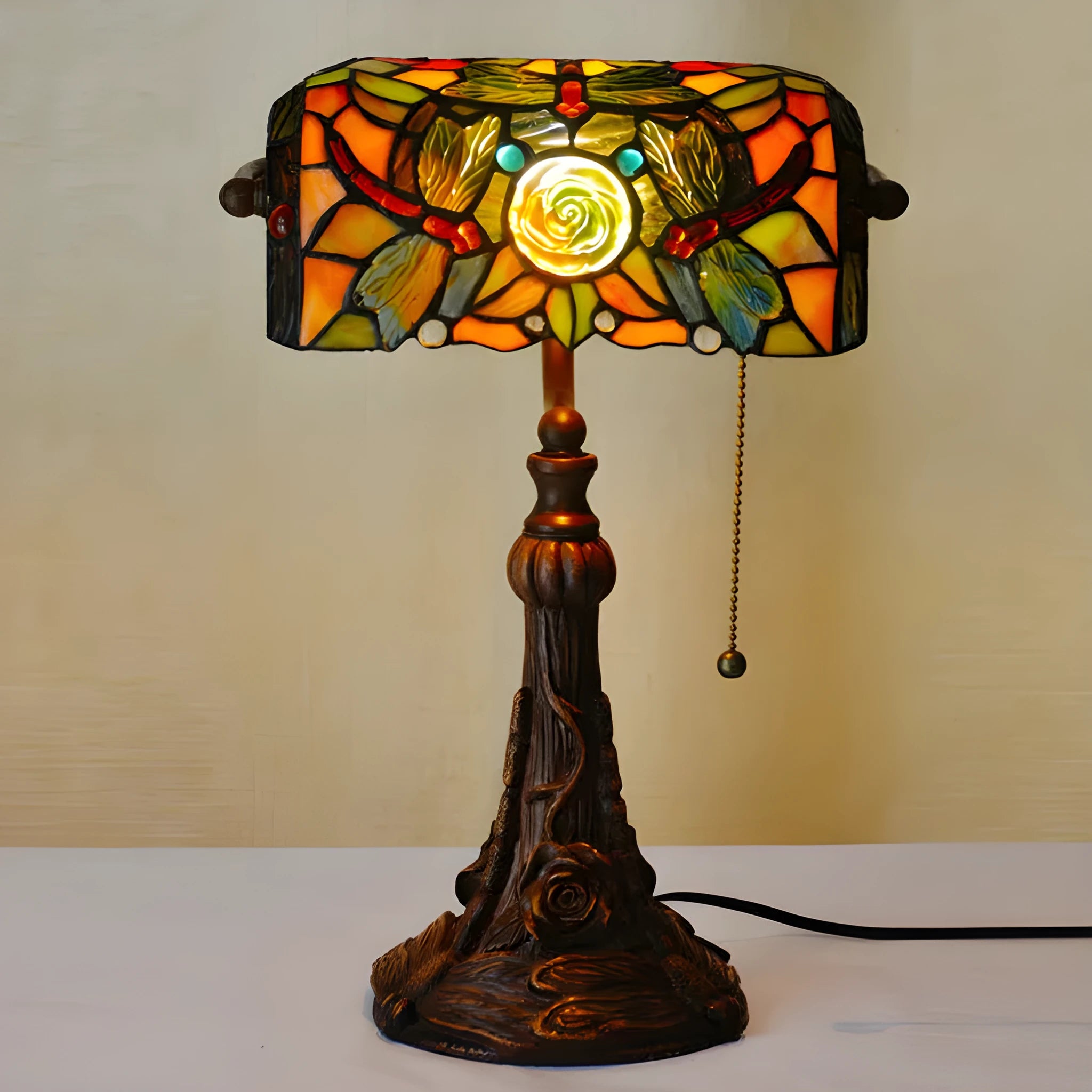 10-inch Tiffany desk lamp with coloured stained glass shade and resin base on a wooden table.