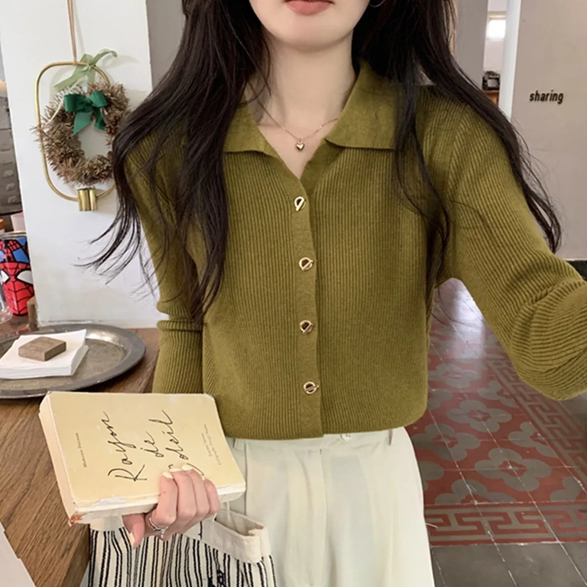 Long-sleeved beige viscose knit cardigan top shown on a hanger, demonstrating its loose fit and regular sleeve length.