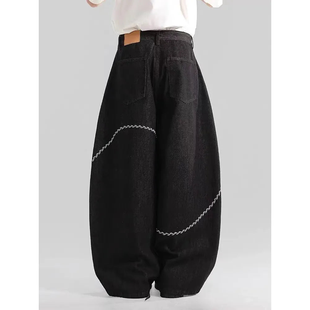 Black Pu Shuai straight-leg denim trousers with a mid waist and zip fly, laid flat.
