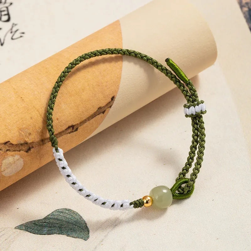 Women's Chinese national bracelet with Hetian jade, sterling silver, and colourful cord carrying strap