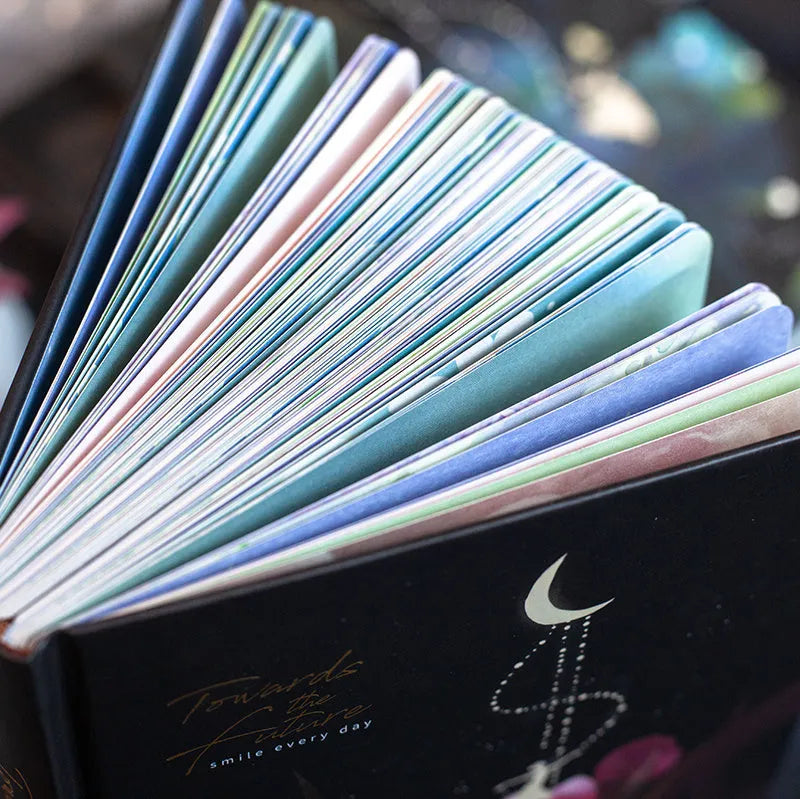 Four A5 hardcover notebooks with luminous covers in deep blue, gold, light blue, and purple colours.