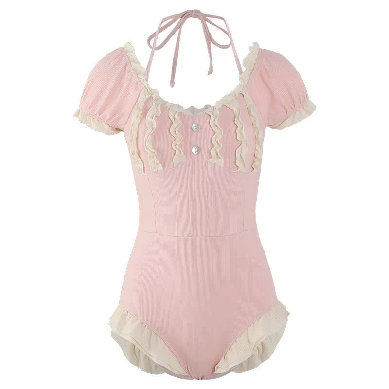 Pink women's conservative one-piece Siamese swimsuit on a hanger.