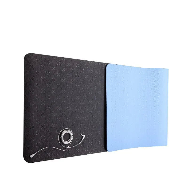Blue yoga mat with plants pattern and a black grounding wire attached.