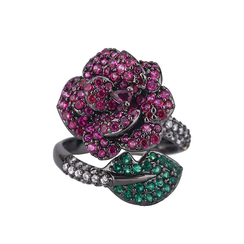 Women's black gold-plated geometric ring with red simulated corundum stones on a copper base.