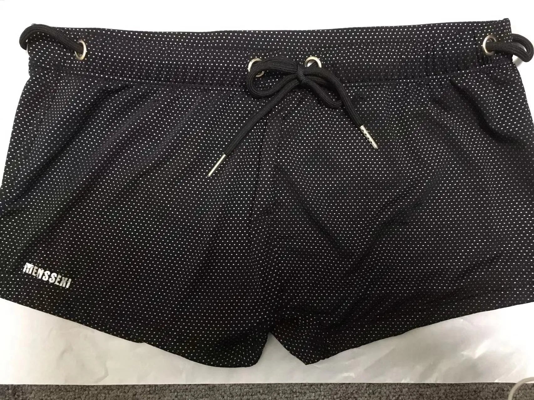 Men's solid colour nylon swimming trunks with polyester lining, shown in multiple colour options.