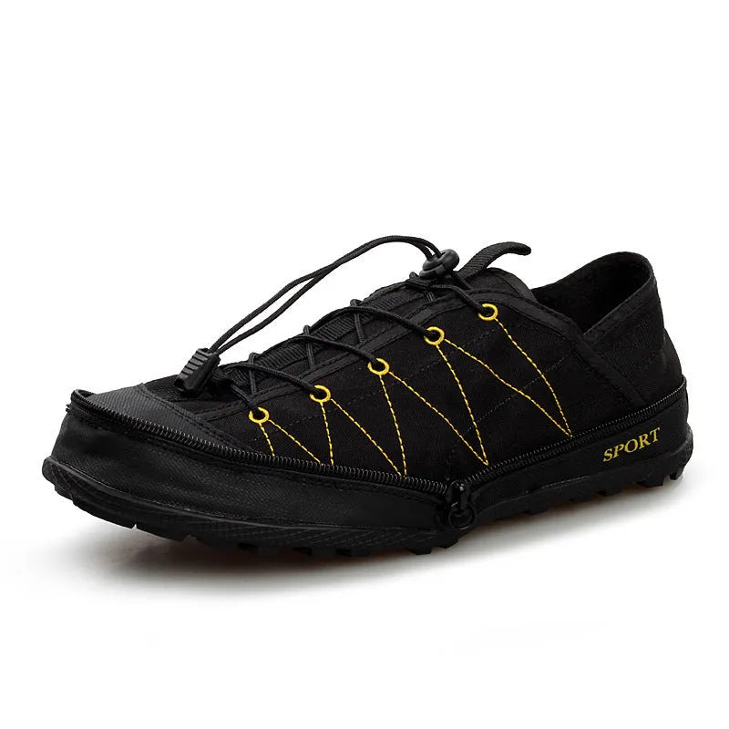 Orange foldable river trekking shoes with mesh upper and side zipper, shown compressed for storage.