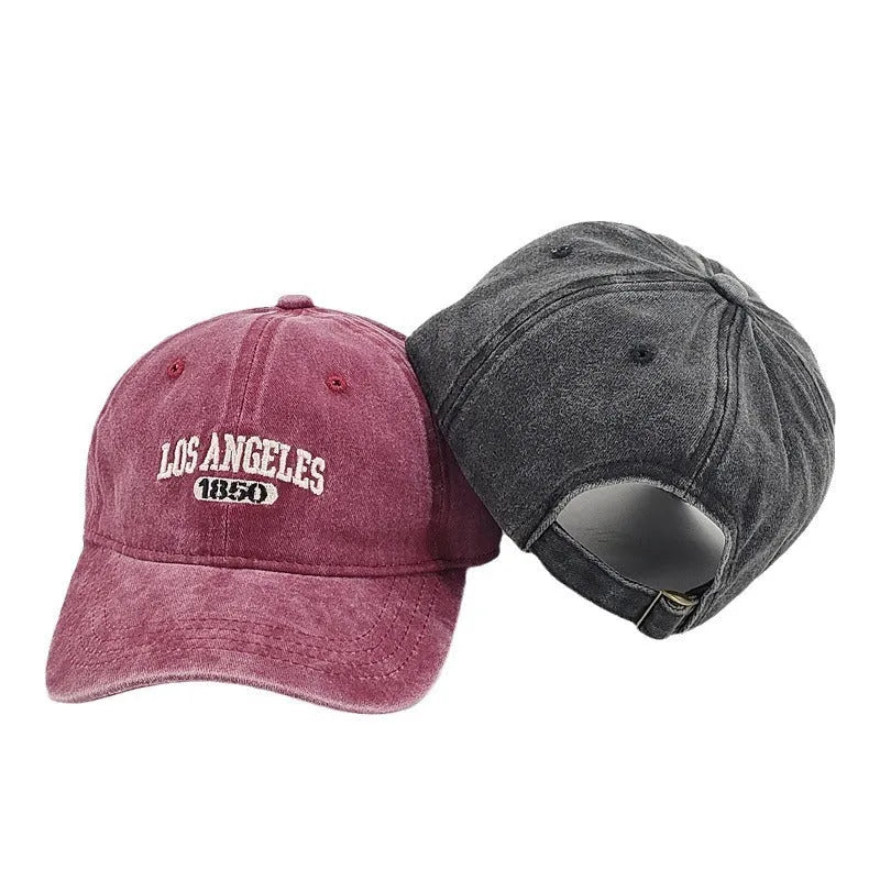 Adjustable peak cap with embroidered letters in distressed retro style, showing conical crown and 7cm brim