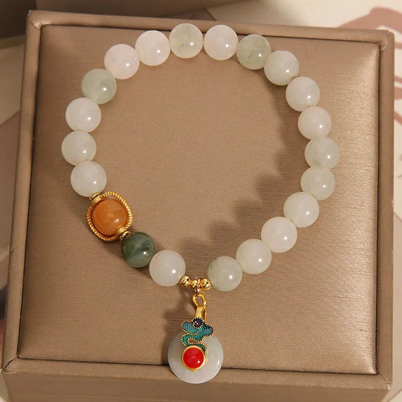 Women's Ice Jade jade bracelet with a Xiangyun peace buckle and pearl details on a white background.