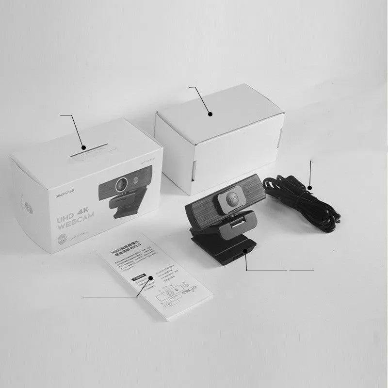 Black USB computer webcam with magnetic privacy cover on a desktop