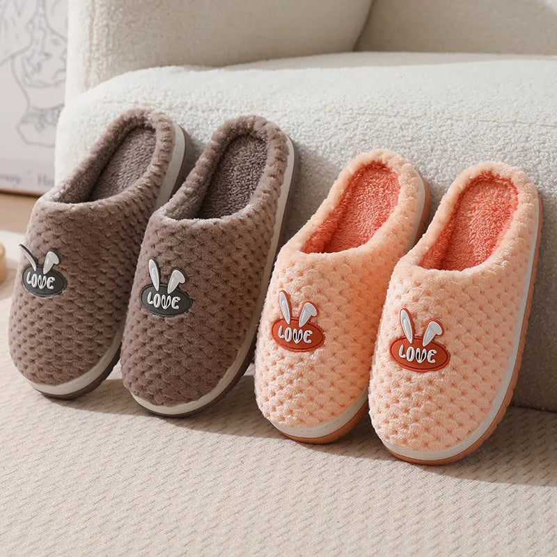 Women's rabbit plaid design artificial fur house slippers with a thick non-slip rubber sole.