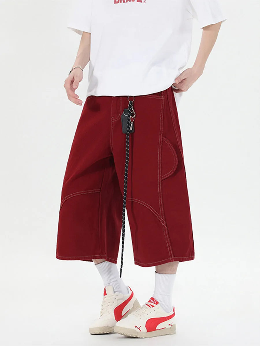 Women's retro denim shorts with multiple pockets in a wide-leg cropped style on a hanger.