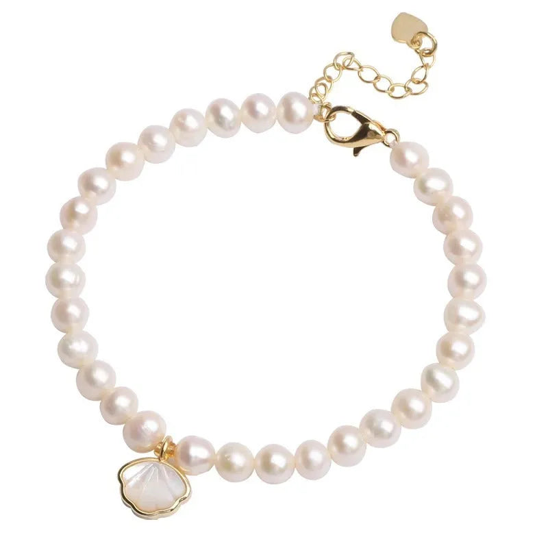Freshwater pearl bracelet with fan-shaped shell design showing pearls on elastic or chain option