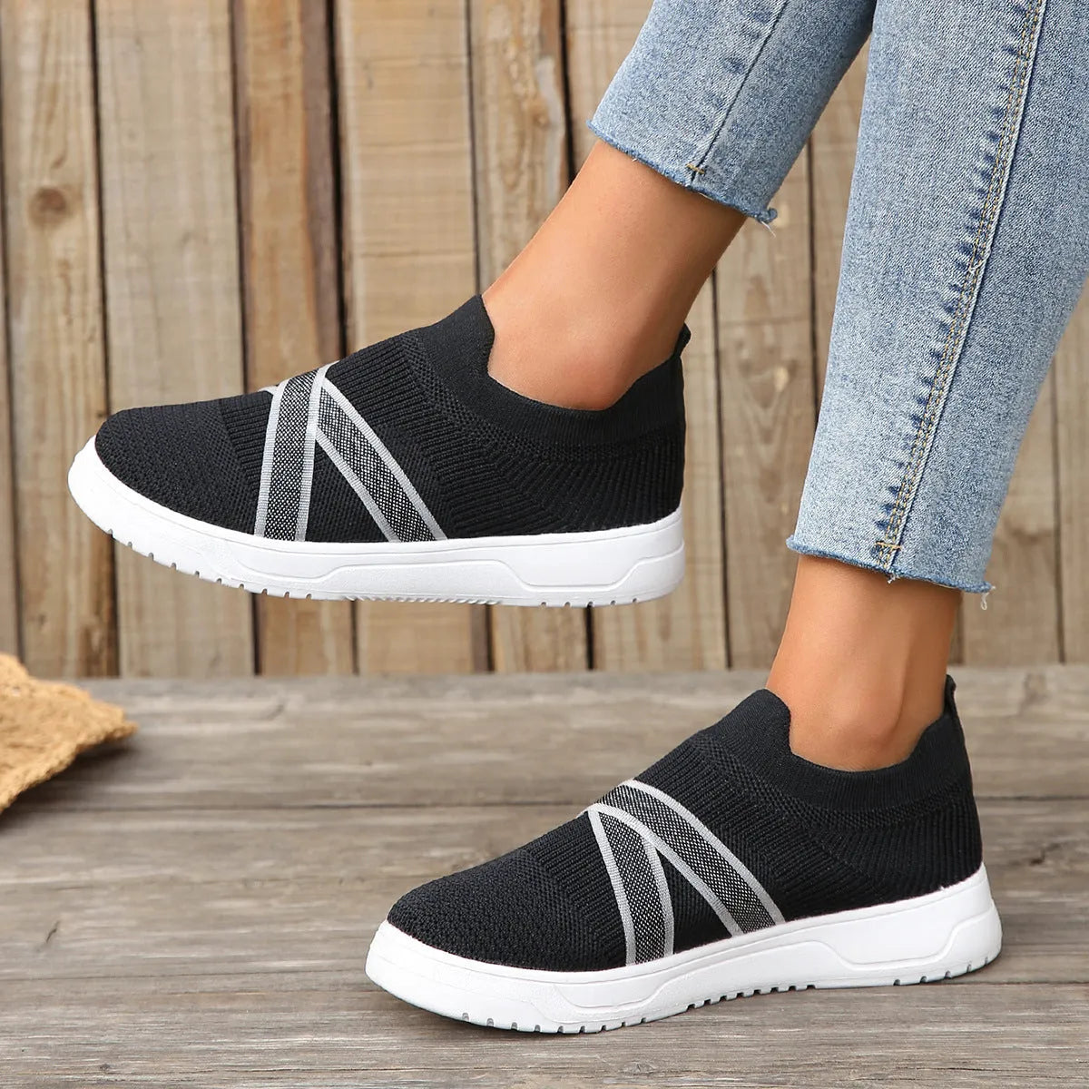Women's black flat bottom flyknit mesh shoes with tassel detail, round toe, and rubber sole
