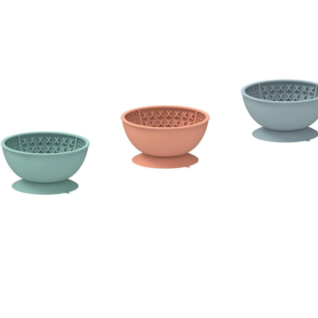 Cyan silicone pet bowl with textured slow feeder pattern and a suction cup base
