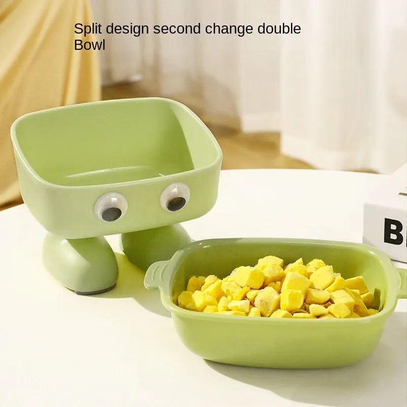 Green elevated cat bowl with robot shape design on anti-slip base showing tilted angle for feeding