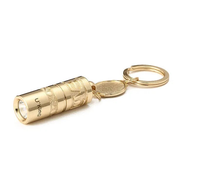 Gold-coloured waterproof mini LED flashlight on a keychain ring.