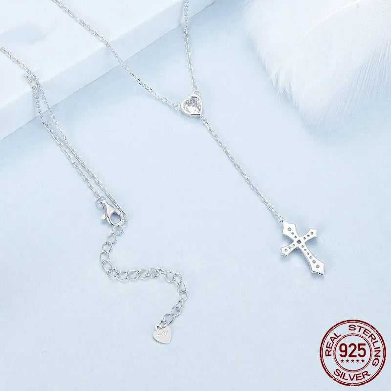 Simple sterling silver cross necklace with V-neck pendant on an O-ring chain.