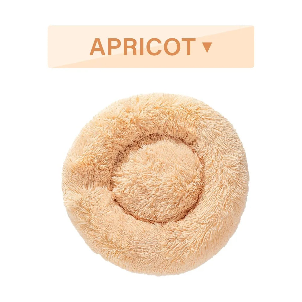 Fluffy donut-shaped dog bed in long plush fabric, shown in a light grey colour without a zipper.