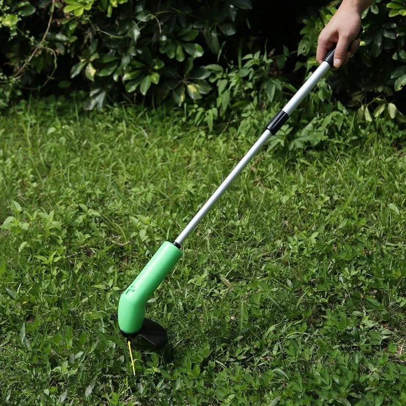 Cordless handheld zip trimmer with extension pole and debris shield on grass