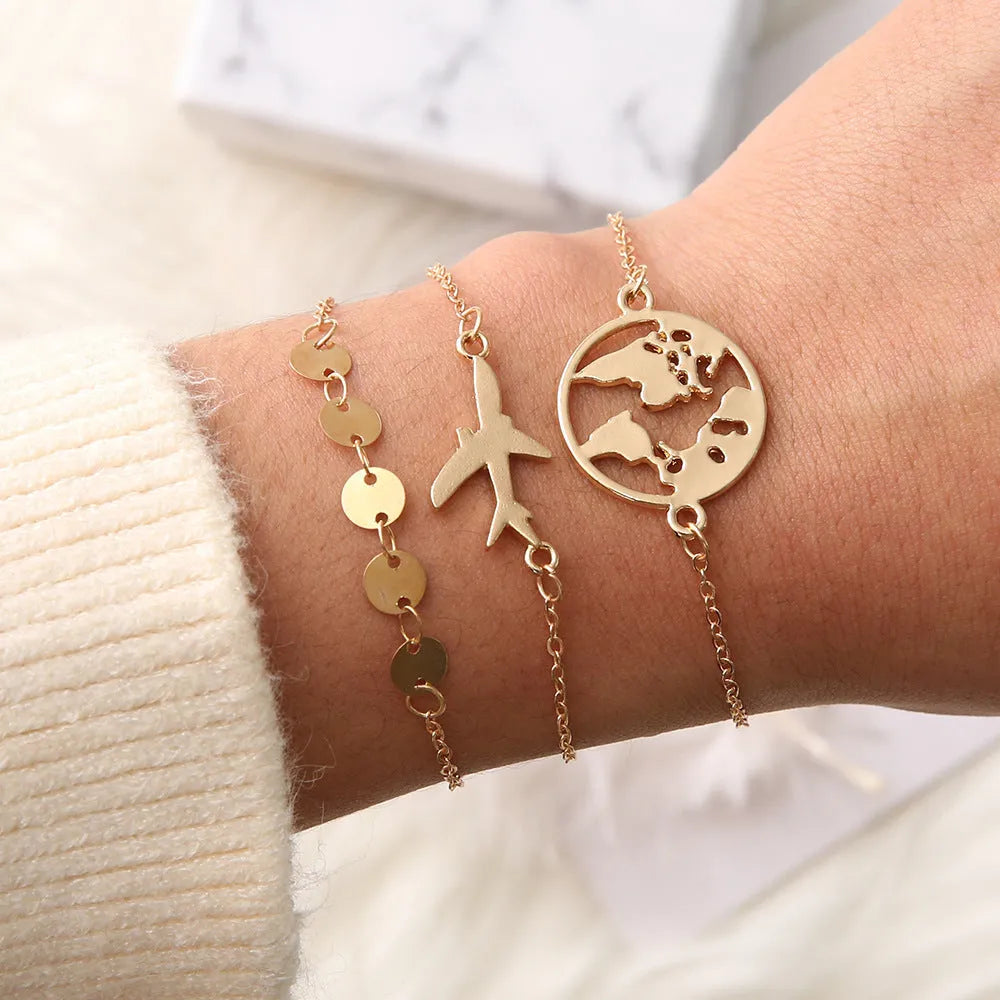 Set of three women's bohemian bracelets with heart-shaped aircraft map charms.