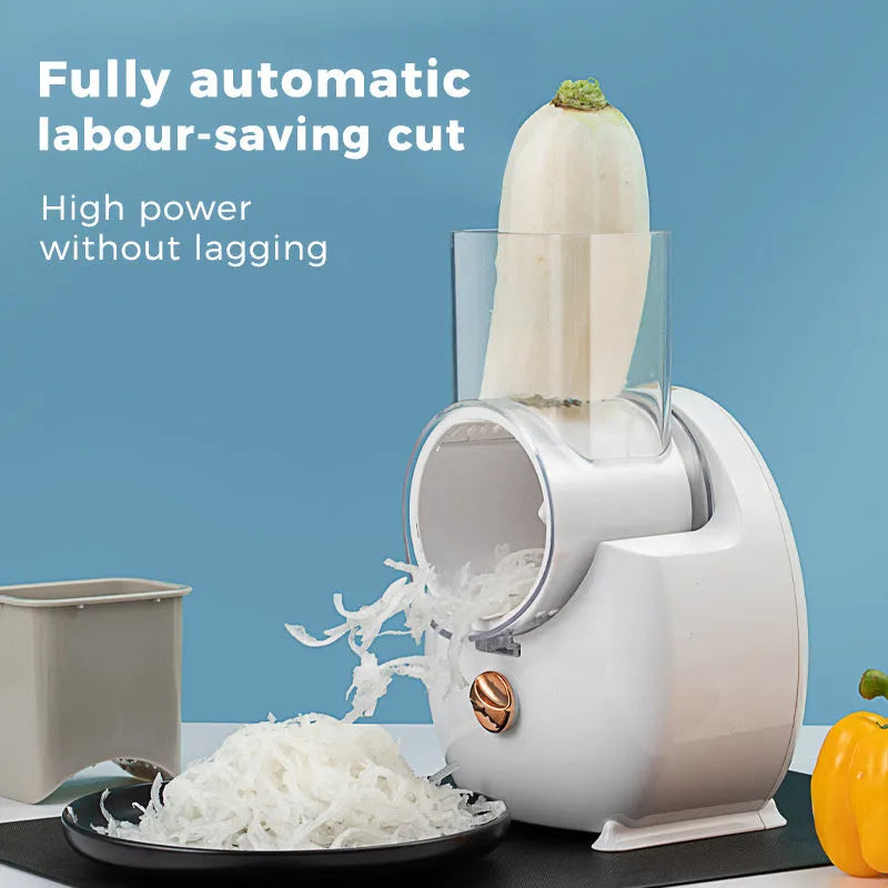 White electric vegetable slicer with rotary blades, suction base, and feeding port on a kitchen counter.