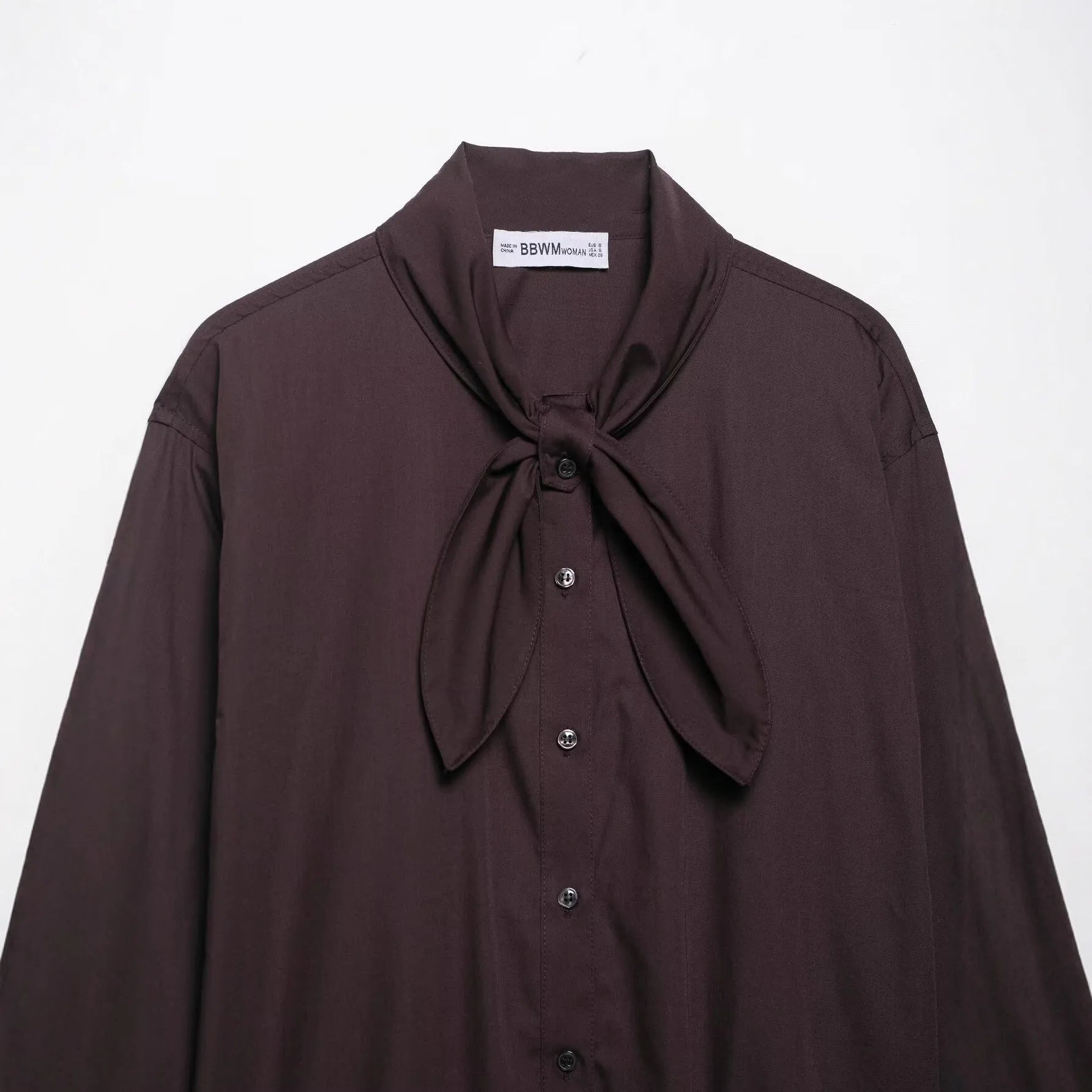 Women's brown loose-fit long sleeve poplin shirt with attached scarf bow tie, front view
