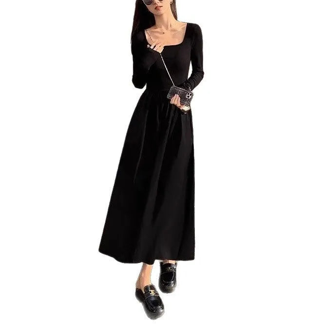 Black knitted square collar dress with long sleeves and an A-line long skirt on a model.