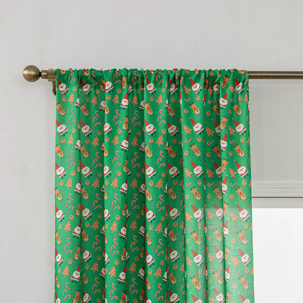 Green Christmas curtain with printed snowman and angel cartoon pattern, one metre wide.