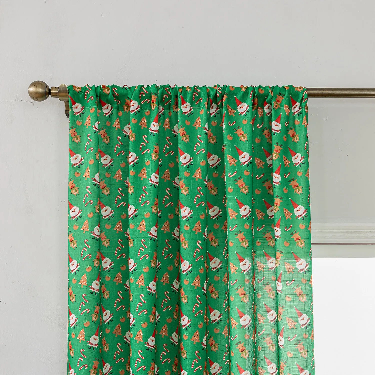 Green Christmas curtain with printed snowman and angel cartoon pattern, one metre wide.