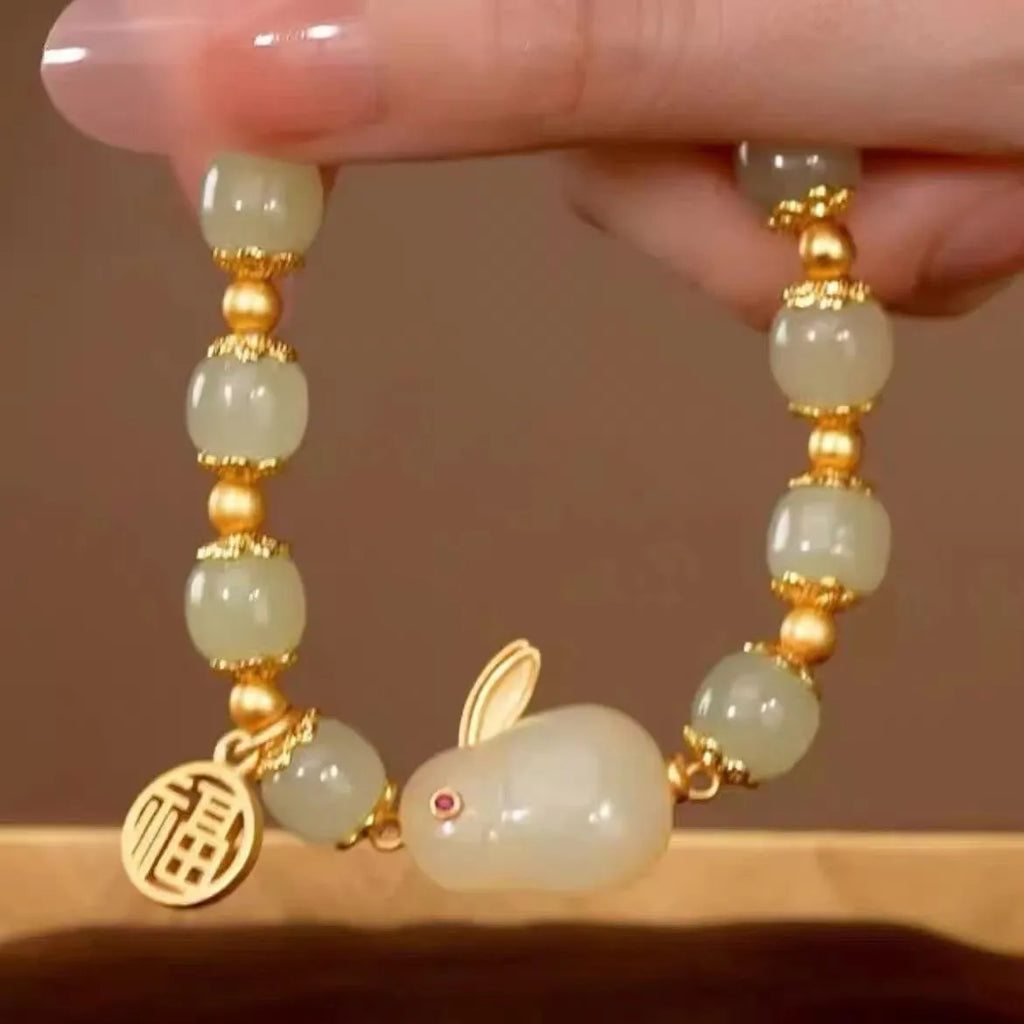 Women's green jade bracelet with fu character hare pendant and lily element on black adjustable cord