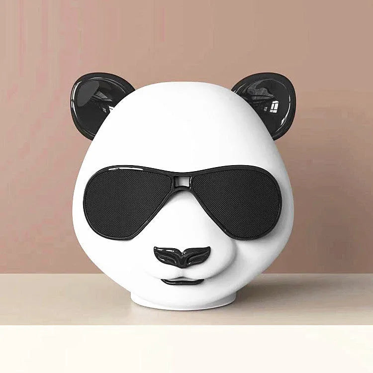 Portable mini Bluetooth speaker in classic style showing front grille and compact size.