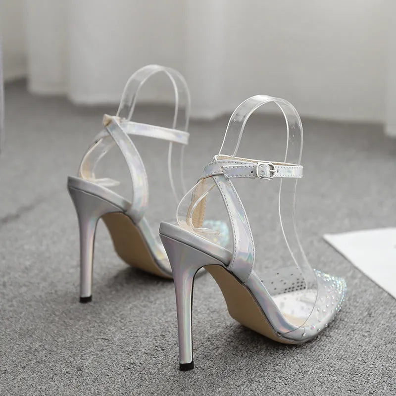 Silver glitter pointed-toe women's sandals with stiletto heels and diamond detailing.