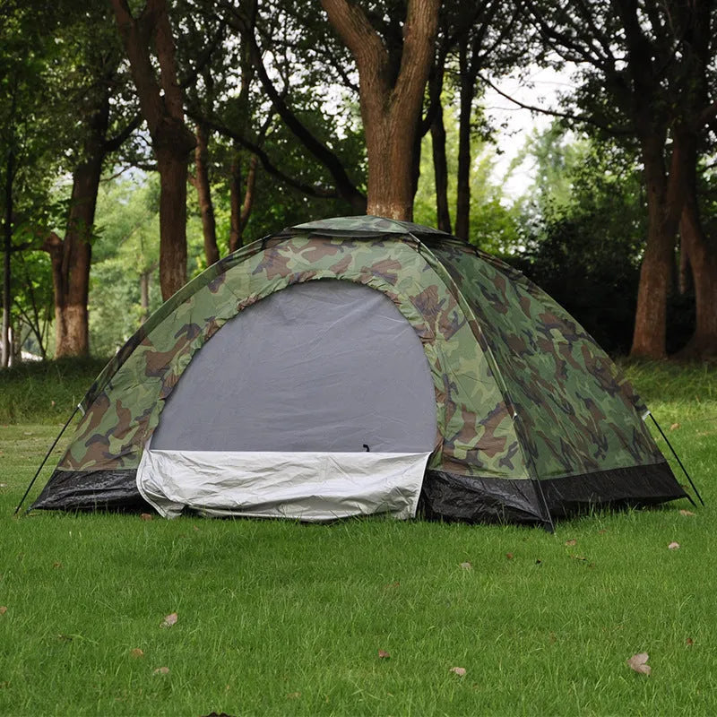 Green camouflage camping tent with triangular skylight, breathable mesh panels, and steel ground nails set up outdoors