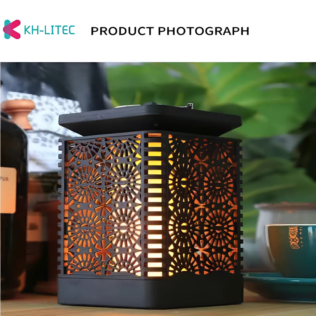 Set of four black solar-powered hanging flame torch lights for outdoor garden decoration.