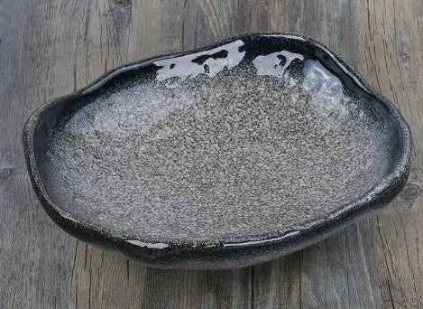 Japanese ceramic sashimi bowl with irregular shape and floral decorations