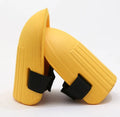 A pair of black EVA foam knee pads for gardening, showing their rectangular shape and thickness.