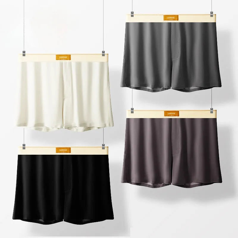Pack of three pairs of solid colour men's loose fit ice silk underwear on a white background.