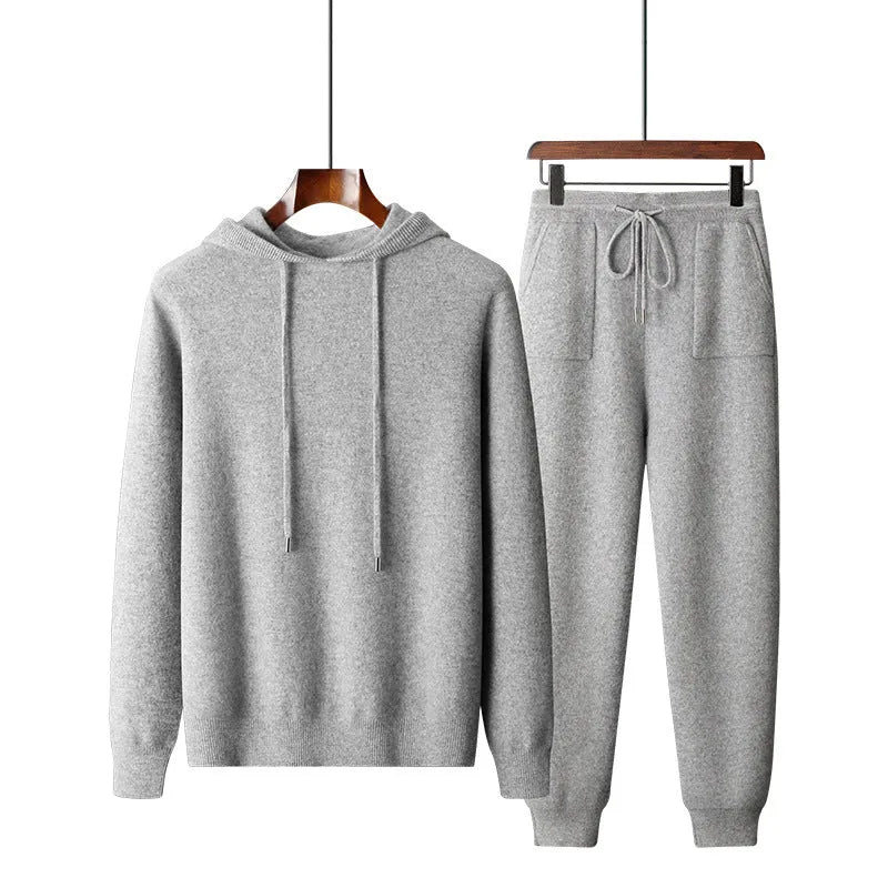 Men's light gray cashmere hooded sweatshirt and matching track pants laid flat.