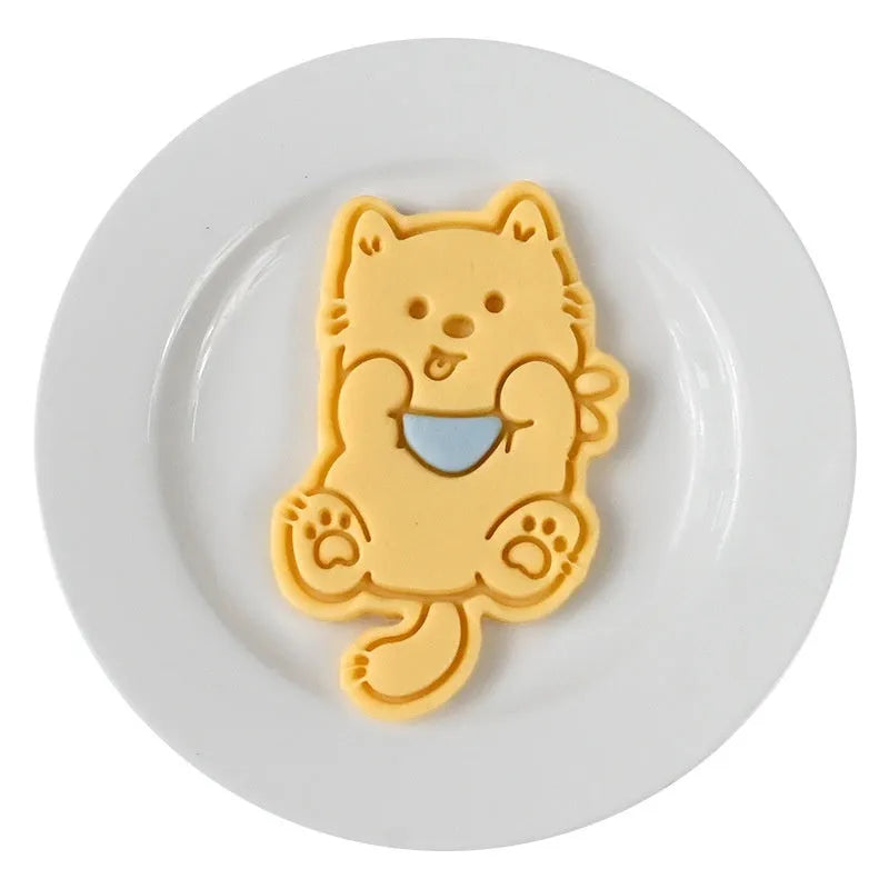 Three-dimensional plastic biscuit mould with cartoon puppy designs including birthday hat and swimming ring patterns