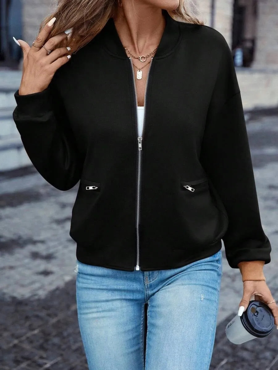 Black women's casual long sleeve zip jacket with faux pocket detailing on a model