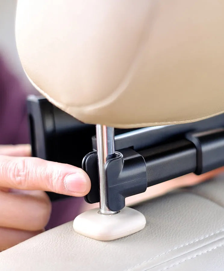 Black plastic car phone holder mounted on rear seat base holding a tablet for navigation