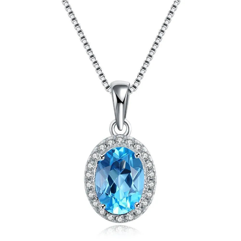 Women's sterling silver jewellery set with blue topaz gems featuring geometric earrings, ring, necklace and pendant
