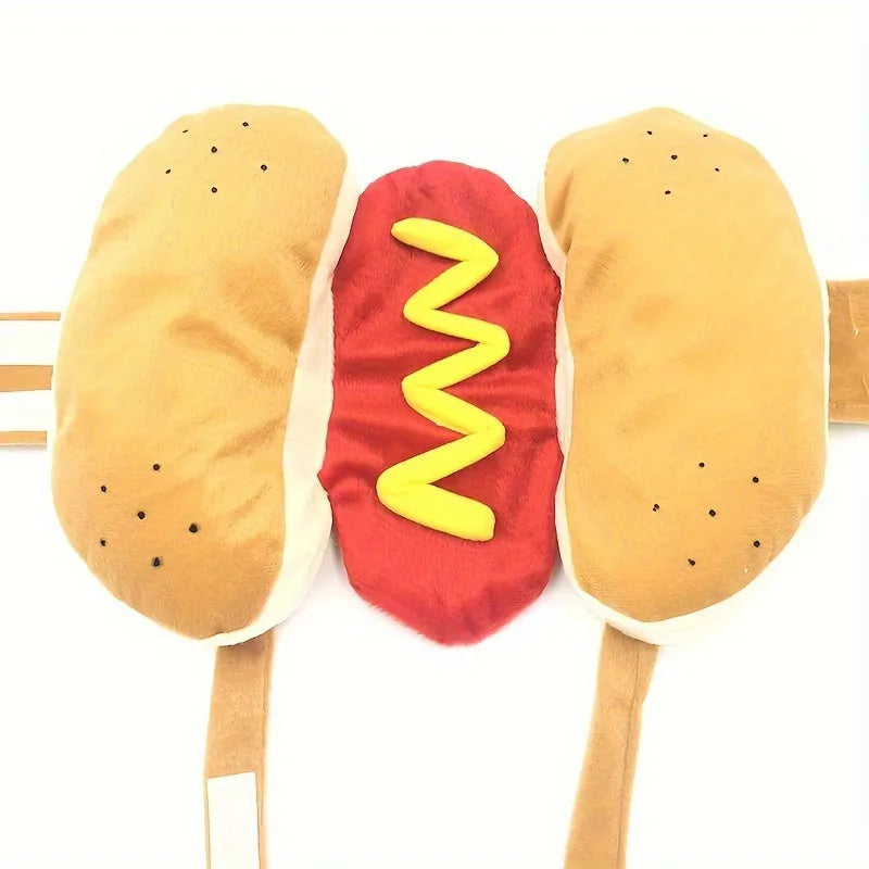 A small dog wearing a plush red and brown hot dog costume with elastic straps.