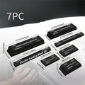 Set of seven black frosted metal alignment blocks for workshop use.
